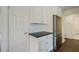 View of the kitchen area featuring white cabinets, stainless steel refrigerator and subway tile backsplash at 2867 Payton Ne Rd, Atlanta, GA 30345