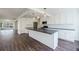 Open concept kitchen boasts white cabinets, stainless steel appliances and dark countertop island at 2867 Payton Ne Rd, Atlanta, GA 30345