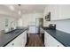 A bright kitchen with stainless steel appliances, white cabinets, and a dark countertop island at 2867 Payton Ne Rd, Atlanta, GA 30345