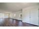 Spacious living room with hardwood floors, white walls, double door closet, and large windows for natural light at 2867 Payton Ne Rd, Atlanta, GA 30345