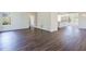 Open-concept living room featuring hardwood floors, white walls, and seamless flow to the kitchen at 2867 Payton Ne Rd, Atlanta, GA 30345