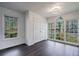 Sun-filled living room featuring hardwood floors, white walls, and many large windows with backyard views at 2867 Payton Ne Rd, Atlanta, GA 30345
