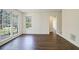 Bright living room featuring hardwood floors, white walls, and large windows with backyard views at 2867 Payton Ne Rd, Atlanta, GA 30345