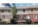 Charming backyard view showcasing the deck, brick facade, and well-maintained landscaping at 545 Woodland Park Ter, Lawrenceville, GA 30043