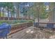 Backyard deck featuring an outdoor grill and furniture surrounded by a natural wooded area at 545 Woodland Park Ter, Lawrenceville, GA 30043