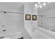 Bright bathroom featuring a bathtub, shower, and modern vanity with sink and mirror at 545 Woodland Park Ter, Lawrenceville, GA 30043