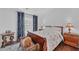 Comfortable bedroom with a queen-sized bed, side tables, lamps, and window with patterned curtains at 545 Woodland Park Ter, Lawrenceville, GA 30043