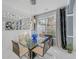 Bright dining area featuring a glass table set, modern chandelier, and views of the backyard at 545 Woodland Park Ter, Lawrenceville, GA 30043