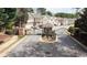 View of the gated entrance to the community featuring mature trees and manicured landscaping at 545 Woodland Park Ter, Lawrenceville, GA 30043