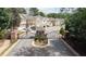 View of the gated entrance to the community featuring mature trees and manicured landscaping at 545 Woodland Park Ter, Lawrenceville, GA 30043