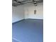 View of the garage featuring an epoxy floor, clean white walls, and overhead lighting at 545 Woodland Park Ter, Lawrenceville, GA 30043