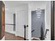 Elegant hallway showcasing a modern chandelier, decorative art, and a staircase with a wrought iron railing at 545 Woodland Park Ter, Lawrenceville, GA 30043