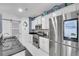 Modern kitchen featuring stainless steel appliances, granite countertops, white cabinets, and stylish backsplash at 545 Woodland Park Ter, Lawrenceville, GA 30043