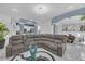 Spacious open-plan living room with large sectional sofa, modern lighting, and stylish decor at 545 Woodland Park Ter, Lawrenceville, GA 30043