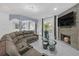 Open-concept living area with fireplace, large sectional sofa, and modern finishes at 545 Woodland Park Ter, Lawrenceville, GA 30043