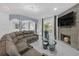 Open-concept living area with fireplace, large sectional sofa, and modern finishes at 545 Woodland Park Ter, Lawrenceville, GA 30043