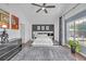 The main bedroom includes a gray area rug, a modern design, and lots of natural light at 545 Woodland Park Ter, Lawrenceville, GA 30043