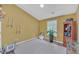 Room with gold walls, decorated with hanging art and a bookcase with audio equipment at 545 Woodland Park Ter, Lawrenceville, GA 30043