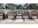 Charming townhomes with attached garages and brick and stone exteriors line a cozy neighborhood street at 545 Woodland Park Ter, Lawrenceville, GA 30043