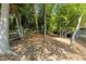 A wooded backyard with a bench and a metal fence at 902 Lenox Hill Ne Ct, Atlanta, GA 30324