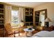 Bedroom featuring built-in shelves, oversized mirror, and hardwood floors at 902 Lenox Hill Ne Ct, Atlanta, GA 30324