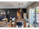 Modern dining area with stylish table, chairs, contemporary lighting, and dark accent wall at 902 Lenox Hill Ne Ct, Atlanta, GA 30324