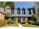 Charming brick home with a unique roofline, manicured landscaping, and a welcoming entrance at 902 Lenox Hill Ne Ct, Atlanta, GA 30324
