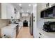 Modern kitchen with white cabinets, stainless steel appliances, and hardwood floors at 902 Lenox Hill Ne Ct, Atlanta, GA 30324