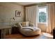 Comfortable living room featuring a chaise lounge, side table, and a large window at 902 Lenox Hill Ne Ct, Atlanta, GA 30324