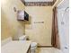 Practical bathroom with a toilet, a shower behind a brown curtain, and decorative wallpaper at 113 Cottage Walk, Cartersville, GA 30121