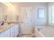 A stylish bathroom featuring a soaking tub, tiled floors, dual sinks and granite countertop at 113 Cottage Walk, Cartersville, GA 30121