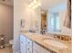 A cozy bathroom featuring dual granite sinks and modern fixtures under a well-lit vanity mirror at 113 Cottage Walk, Cartersville, GA 30121