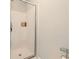 A simple white shower that is enclosed, ensuring a clean and minimalist aesthetic in the bathroom at 113 Cottage Walk, Cartersville, GA 30121