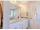 Bright bathroom featuring a double sink vanity with granite countertops and a large mirror at 113 Cottage Walk, Cartersville, GA 30121
