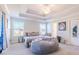A comfortable bedroom is equipped with a suspended ceiling fan, a bed, and a gray bean bag at 113 Cottage Walk, Cartersville, GA 30121