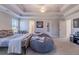 A comfortable bedroom is equipped with a suspended ceiling fan, a bed, and a gray bean bag at 113 Cottage Walk, Cartersville, GA 30121
