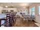 Open-concept design with a dining area connected to a kitchen, hardwood floors, and natural light at 113 Cottage Walk, Cartersville, GA 30121
