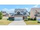 Charming two-story home with stone accents, a two-car garage, and a well-manicured lawn at 113 Cottage Walk, Cartersville, GA 30121