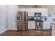 Bright kitchen featuring stainless steel appliances, a modern design, and hardwood floors at 113 Cottage Walk, Cartersville, GA 30121