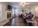 Cozy living room with hardwood floors, a stone fireplace, and comfortable seating at 113 Cottage Walk, Cartersville, GA 30121
