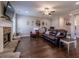 Comfortable living room with a stone fireplace, hardwood floors, and a flatscreen TV at 113 Cottage Walk, Cartersville, GA 30121