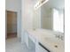 Bathroom featuring a double sink vanity with a large mirror and plenty of storage space at 334 Royal Crescent Way, Stockbridge, GA 30281
