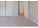 Spacious bedroom featuring plush carpet and large closet space, offering ample storage at 334 Royal Crescent Way, Stockbridge, GA 30281