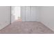 Bedroom featuring neutral carpet flooring, closet, and doorway to the rest of the house at 334 Royal Crescent Way, Stockbridge, GA 30281