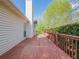 A wooden deck with a painted red floor runs along the side of the house at 334 Royal Crescent Way, Stockbridge, GA 30281