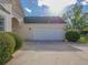 A two car garage with a driveway and manicured bushes in front of the house at 334 Royal Crescent Way, Stockbridge, GA 30281
