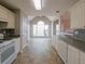 Bright kitchen featuring white cabinets, stainless steel dishwasher, oven and views to outside at 334 Royal Crescent Way, Stockbridge, GA 30281