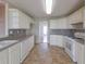 Well lit kitchen featuring tiled backsplash, white cabinets, stainless steel dishwasher and oven at 334 Royal Crescent Way, Stockbridge, GA 30281