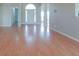 Spacious living room featuring shiny hardwood floors and a bright, welcoming entryway at 334 Royal Crescent Way, Stockbridge, GA 30281