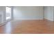 Empty living room featuring hardwood floors and a fireplace with light grey walls at 334 Royal Crescent Way, Stockbridge, GA 30281